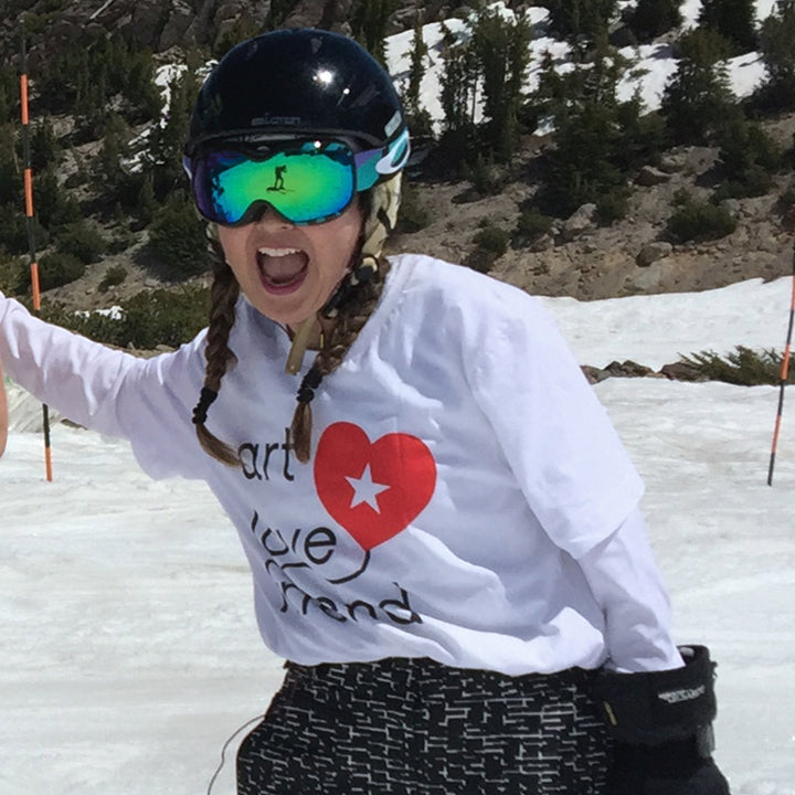 Image of Art Love Friend Logo Short-Sleeve Unisex T-Shirt. T-shirt on female snowboarder.
